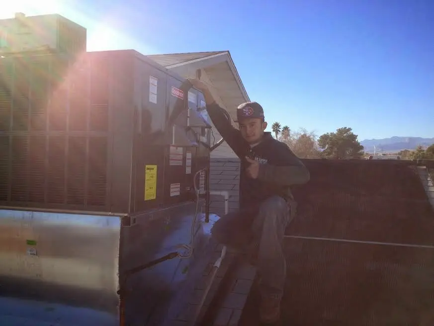HVAC technician performing HVAC Inspection on a rooftop unit in Glenwood